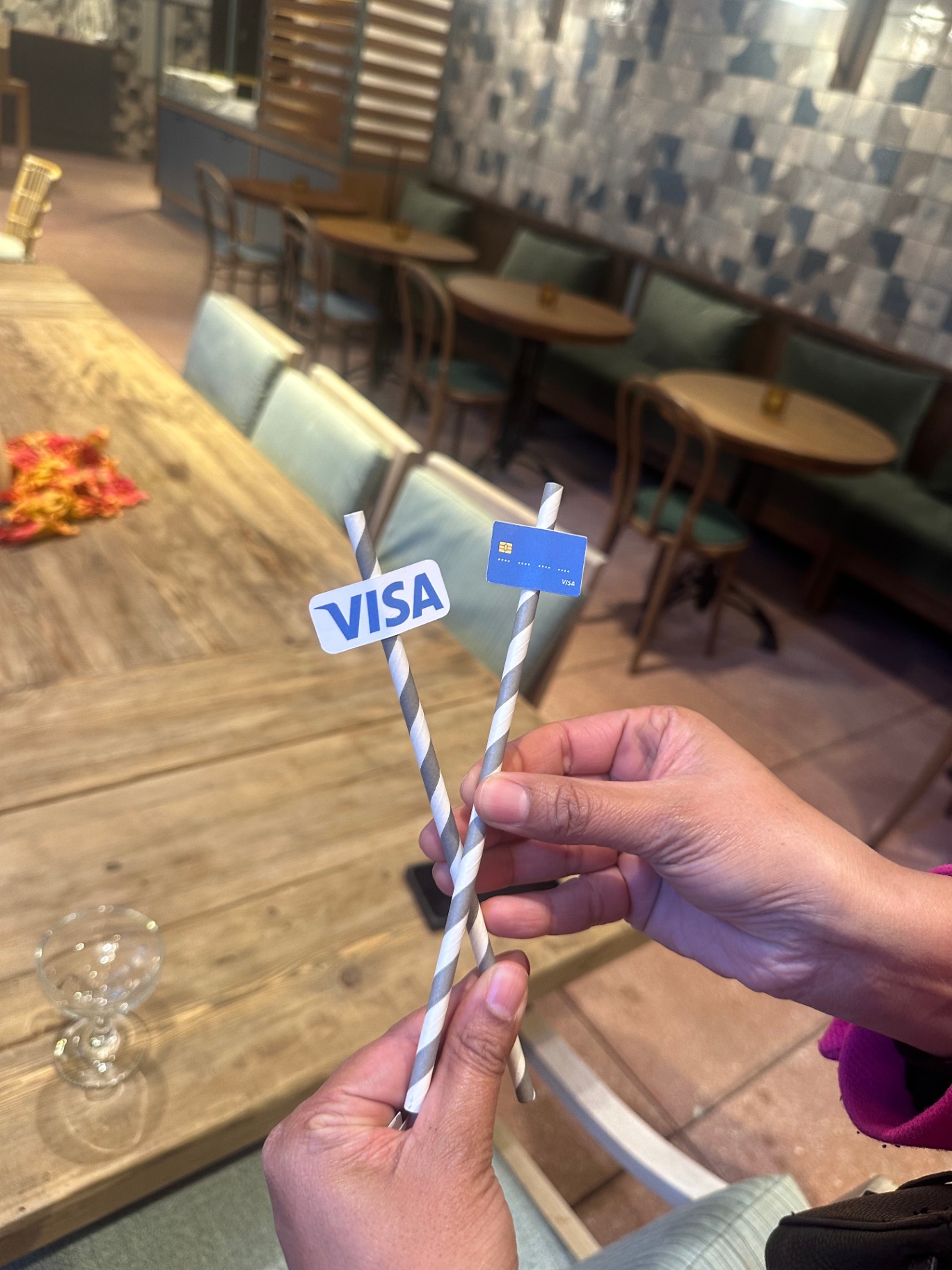 Custom Visa cocktail stirrers held up before the reception
