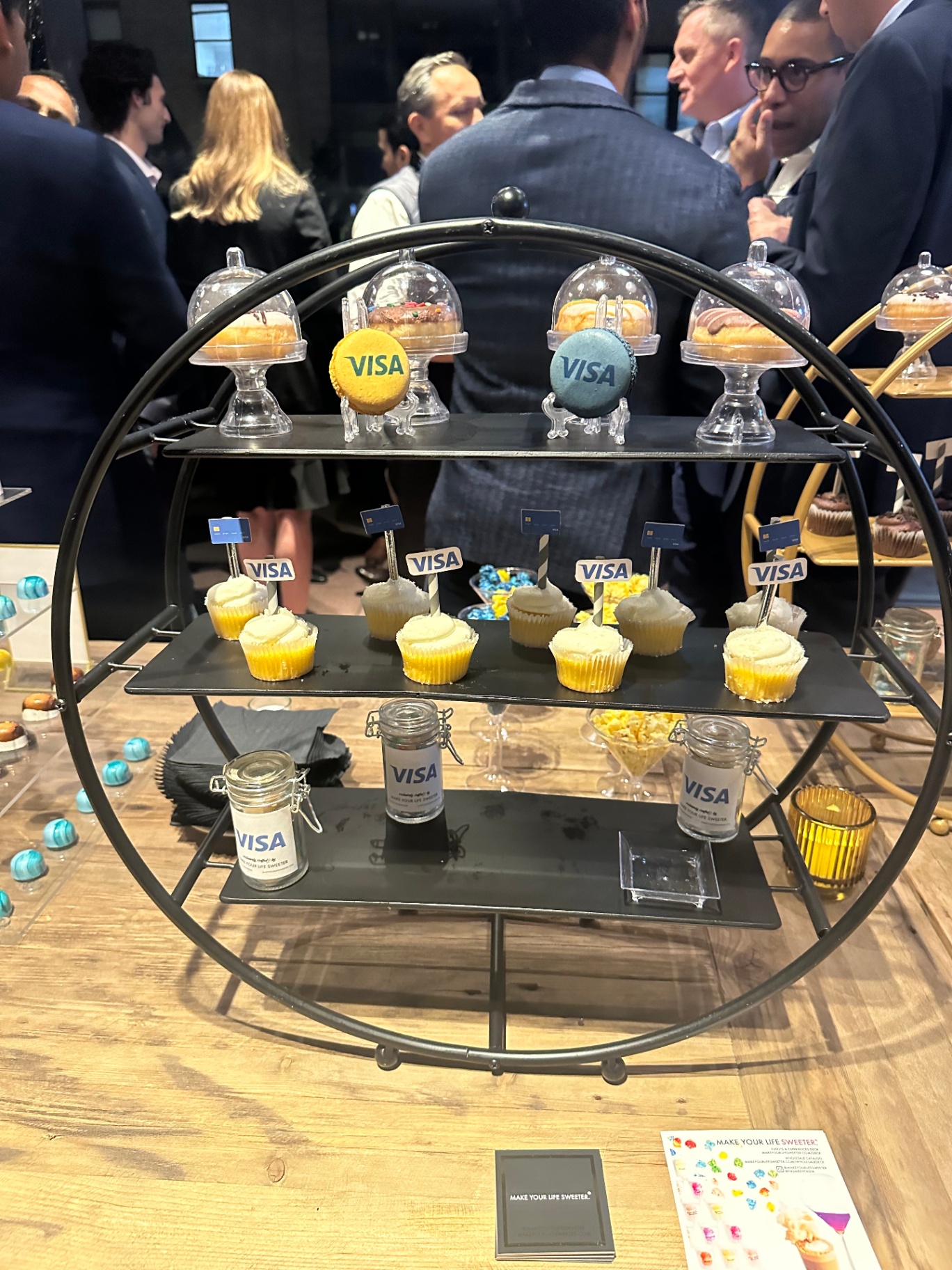 Tiered dessert stand with Visa macarons and cupcakes at the evening reception