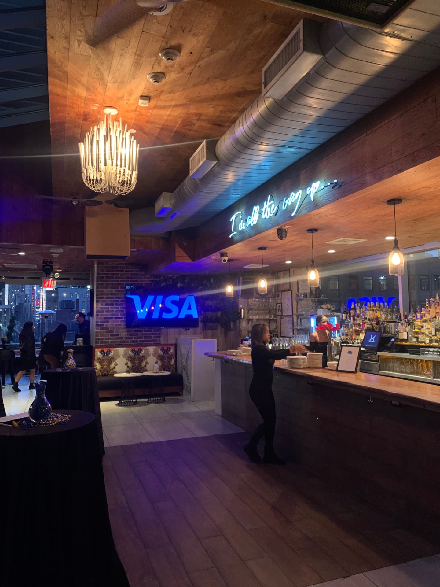 Monarch rooftop bar set up with Visa screens and cocktail tables