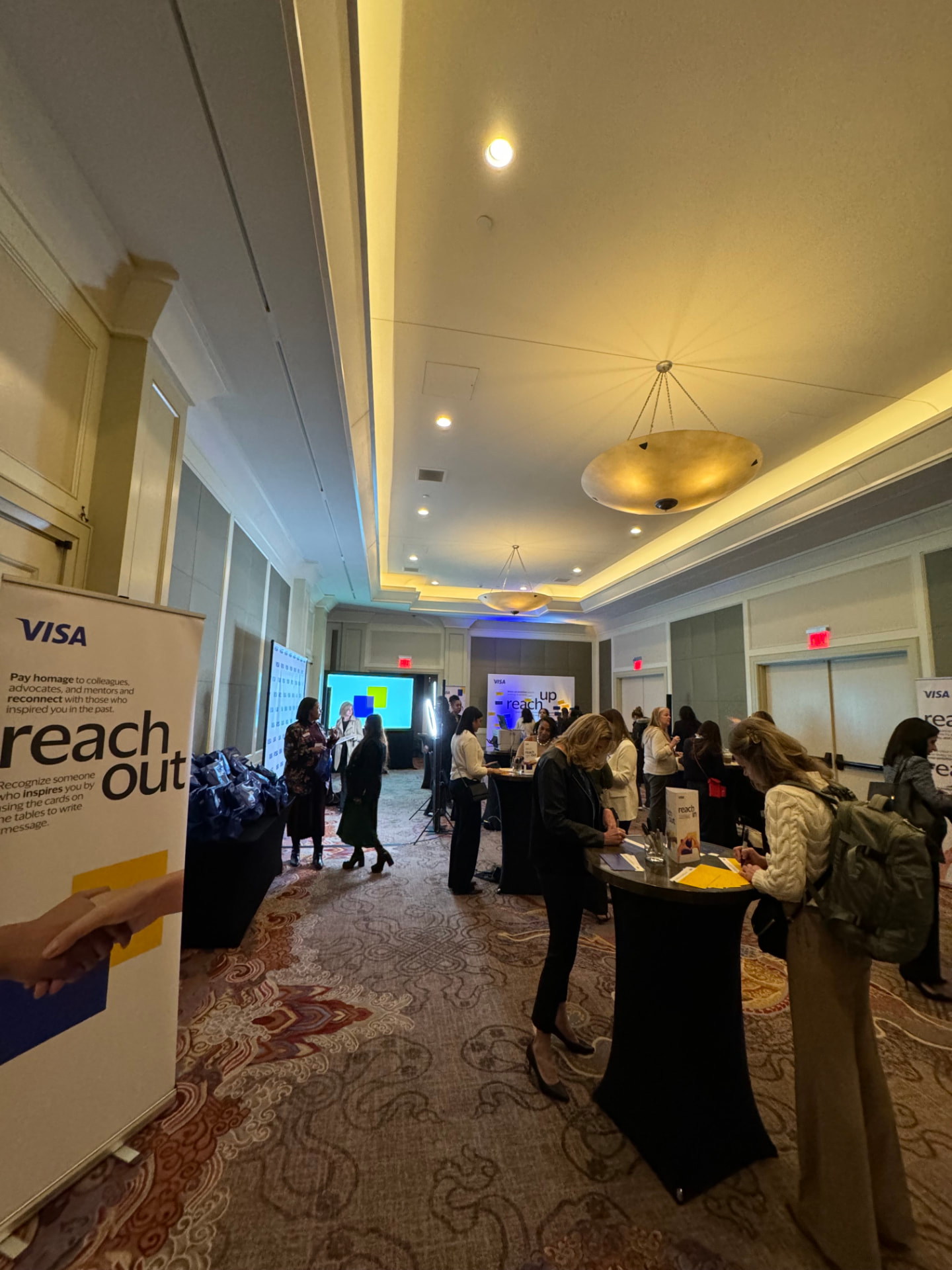 Wide view of the reception with reach in, reach up and reach out banners