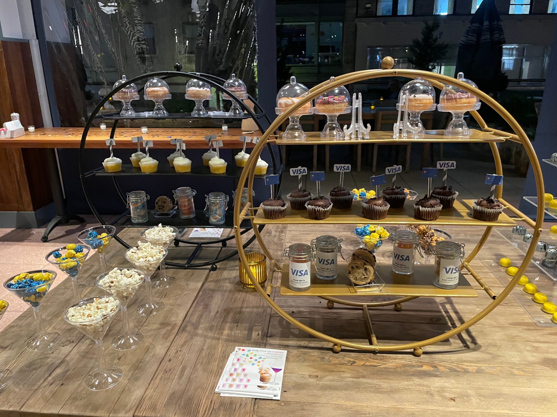 Circular dessert displays with Visa-flagged cupcakes and donuts