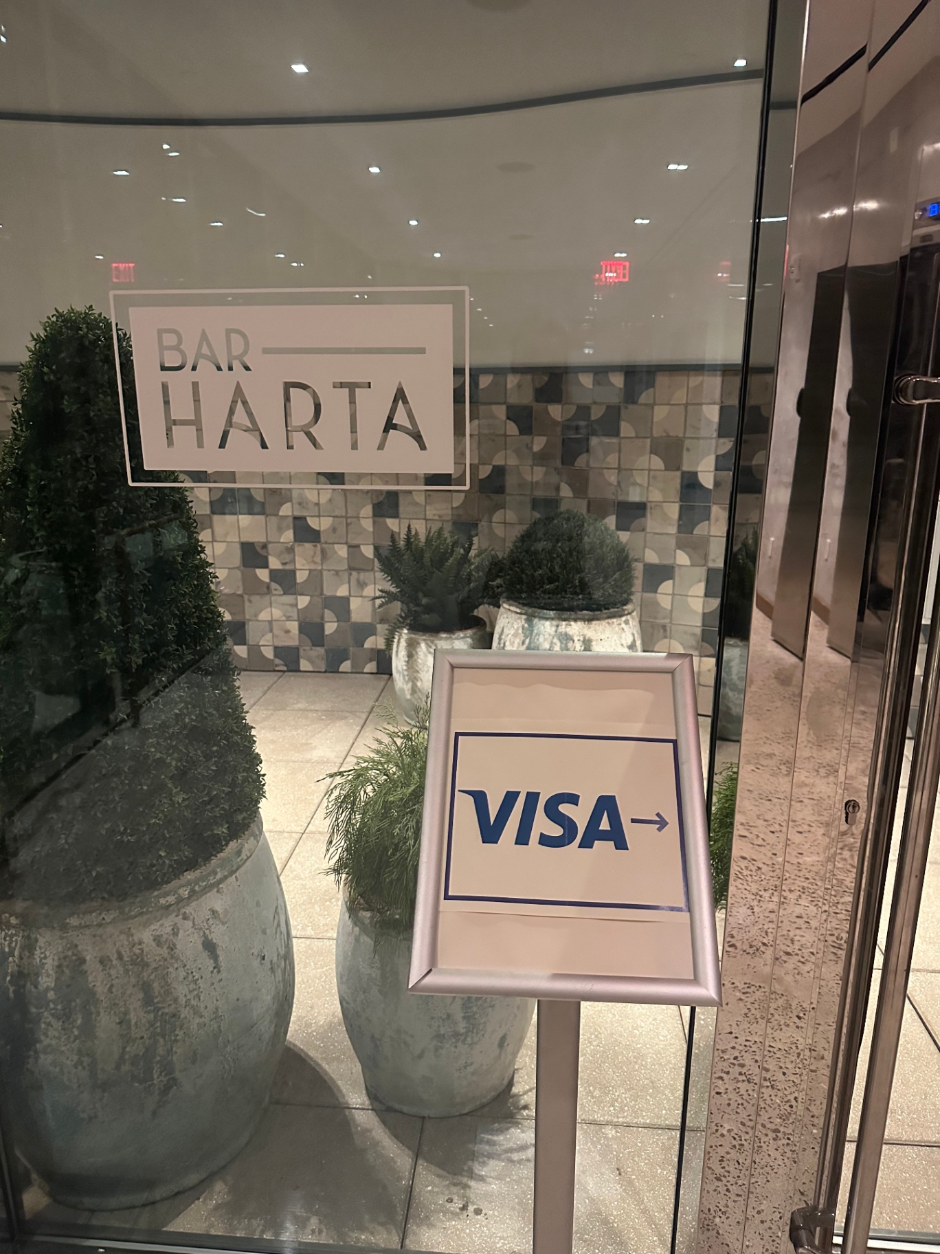 Visa directional signage at the Bar Harta venue entrance
