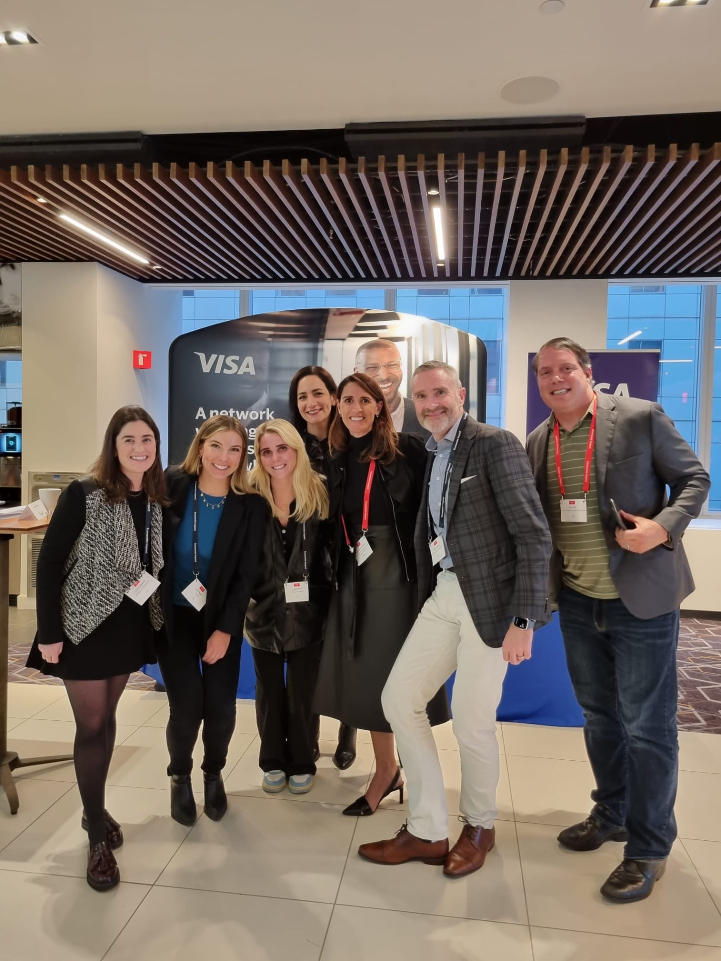 Visa team posing together in front of the Visa booth at CPI Global 2022