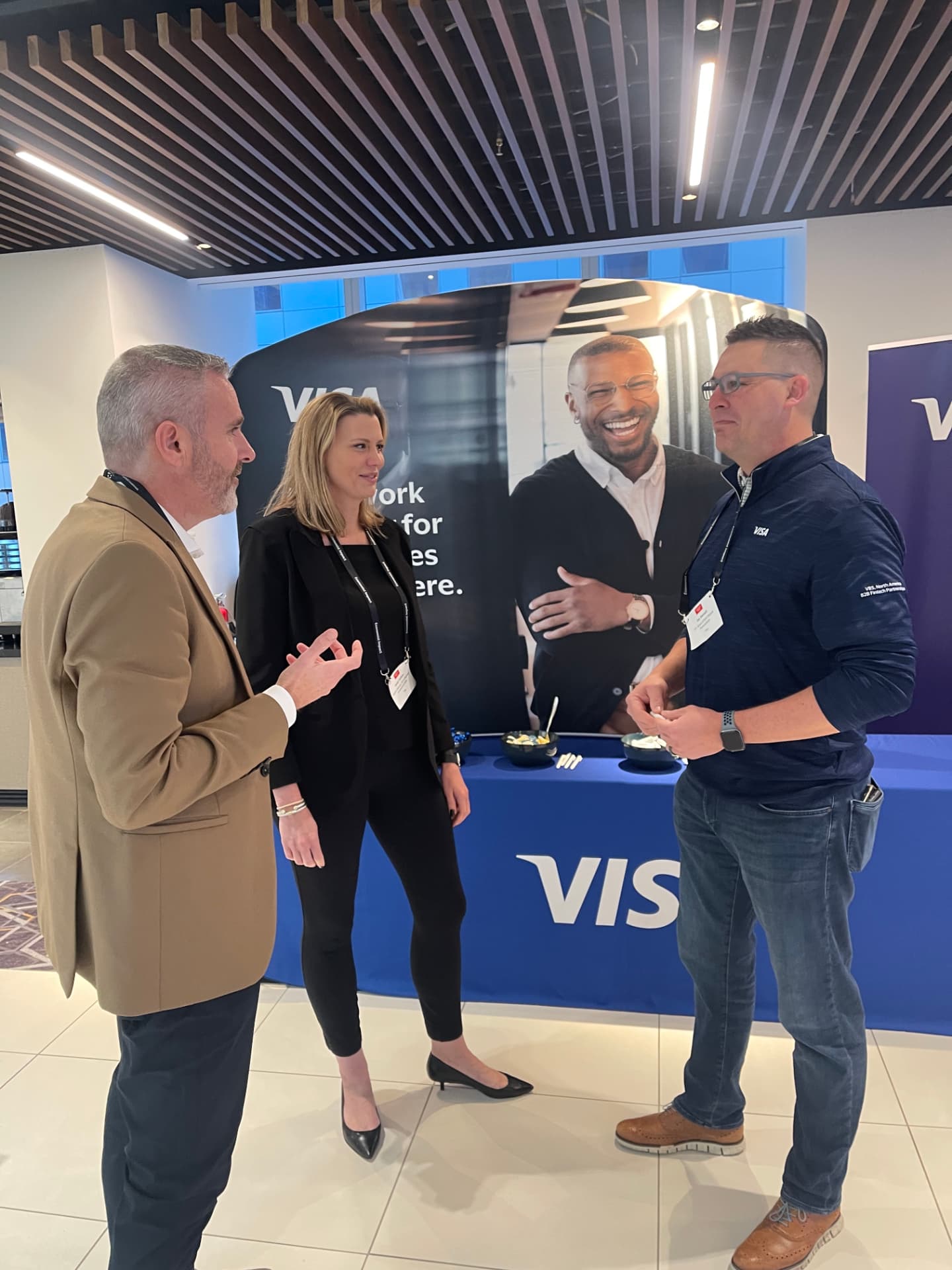 Guests networking beside the Visa booth at CPI Global 2022