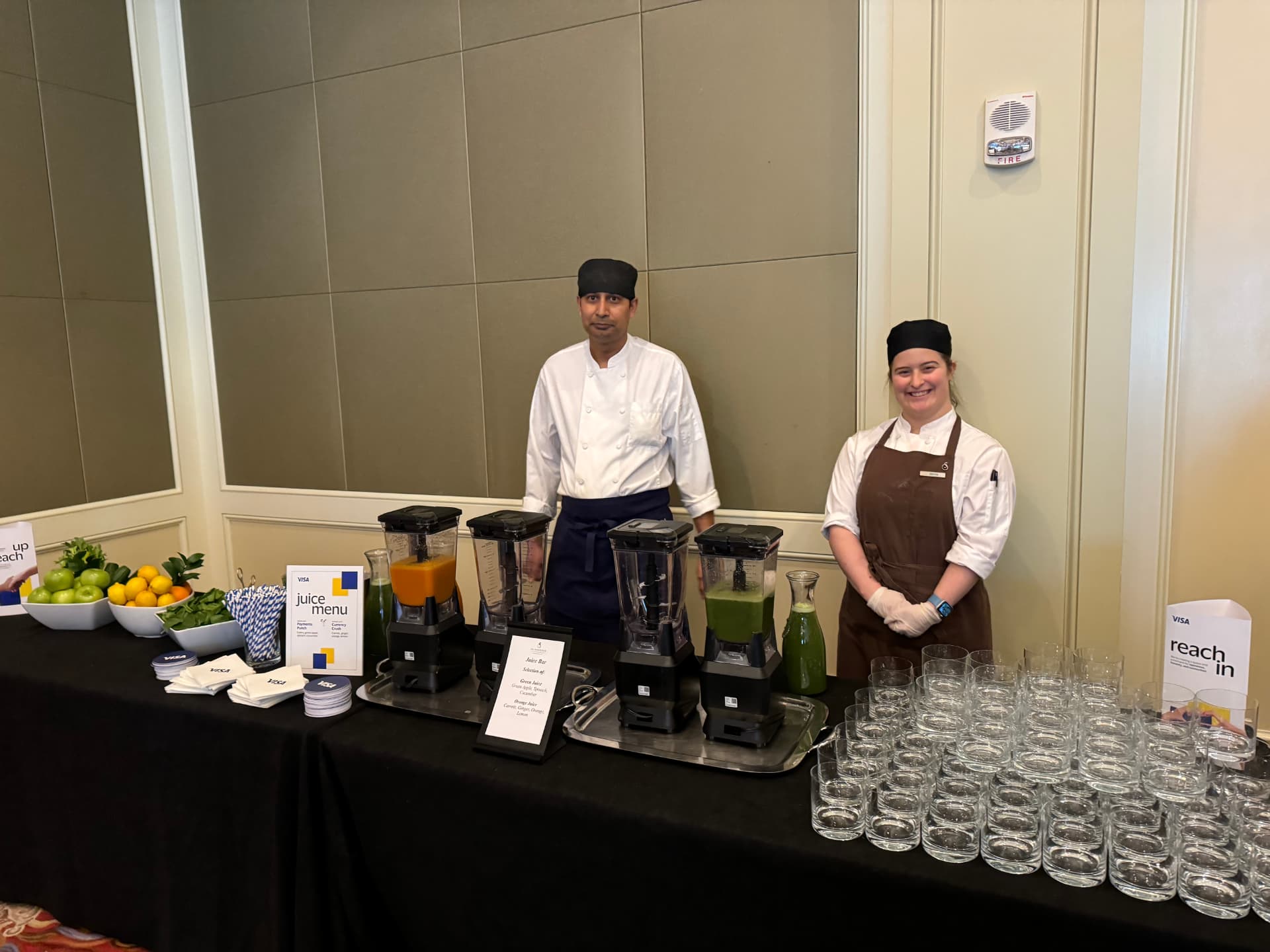 Chefs at the Visa-branded juice bar with fresh fruit and blenders