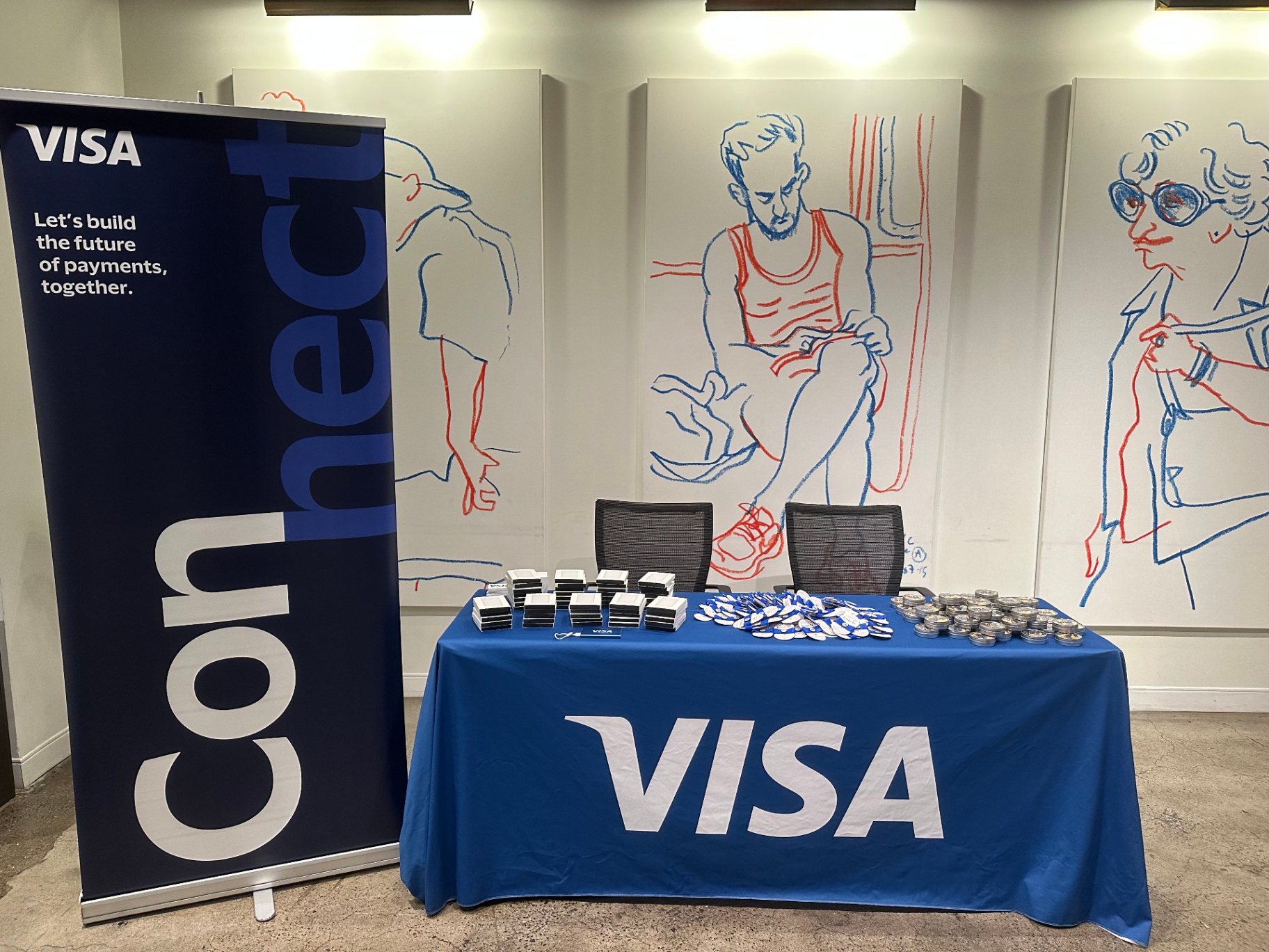Visa-branded activation table with signage, badges and gifts at CPI Global 2023