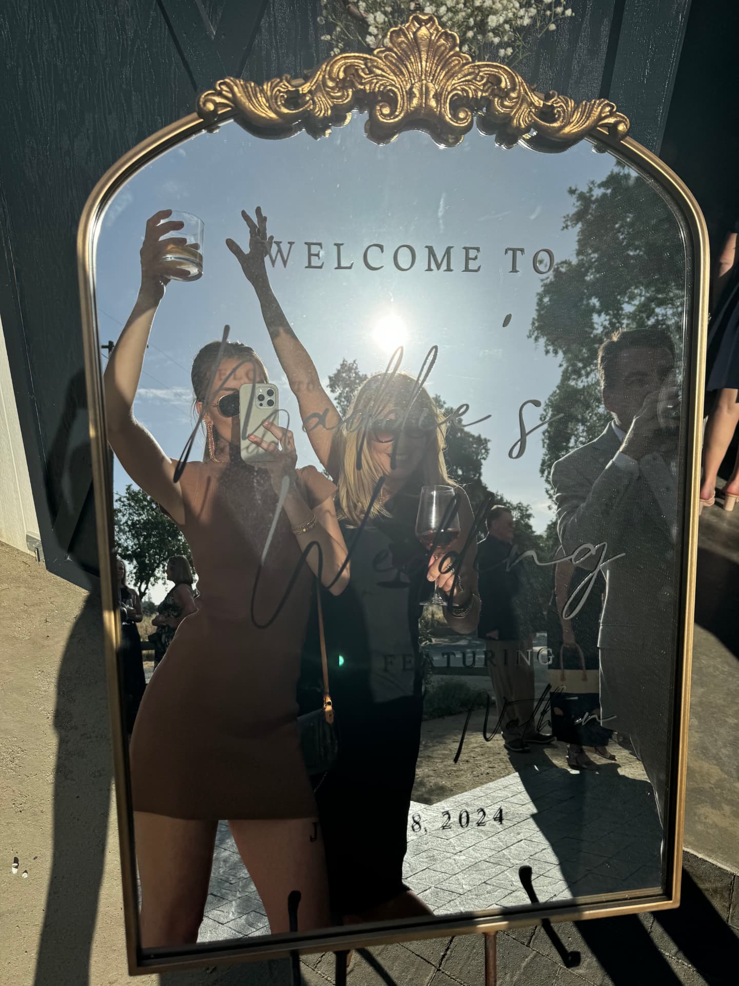 Gold-framed welcome mirror for Maddie and Nathan's wedding at golden hour