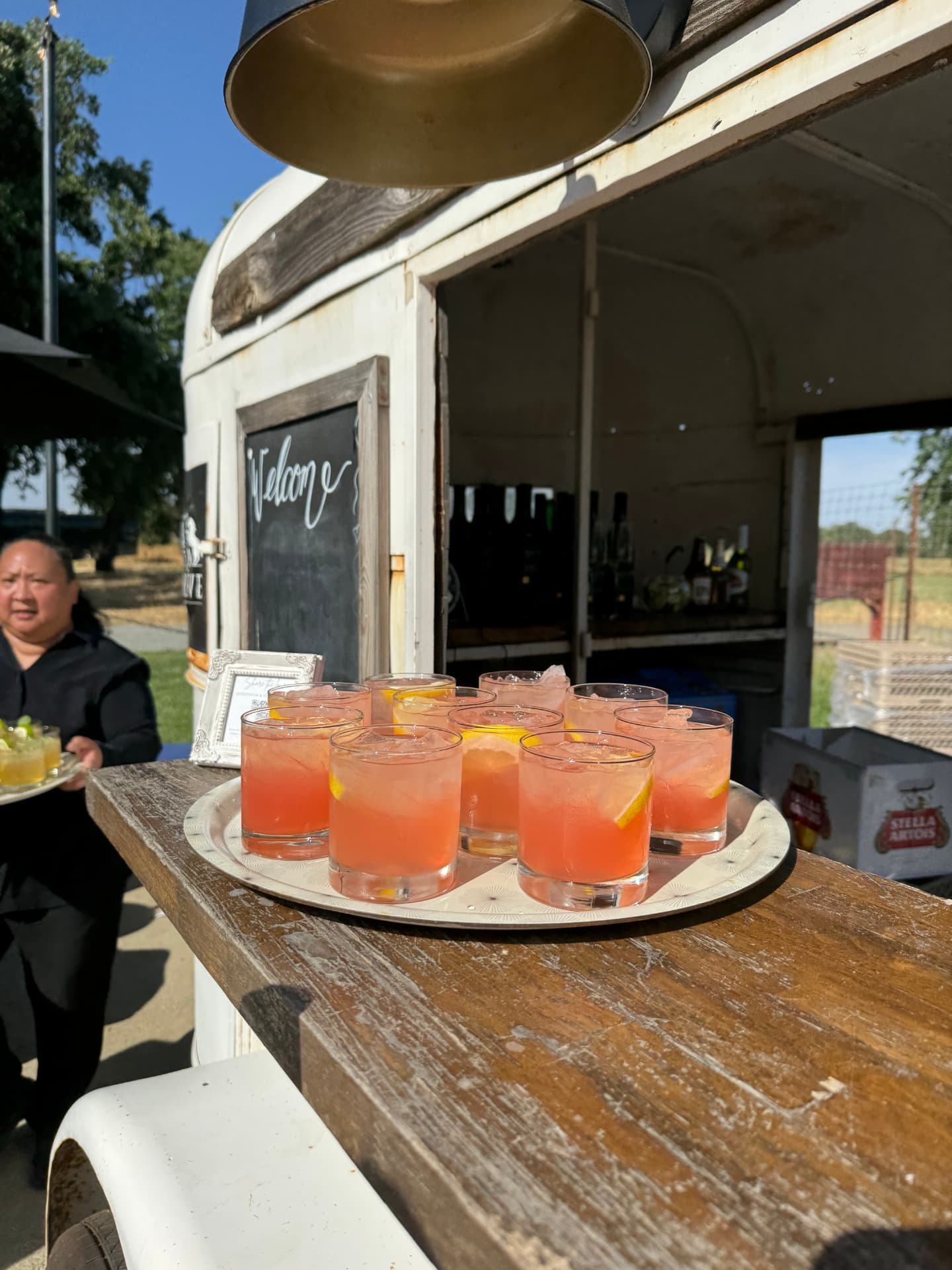 Tray of signature grapefruit cocktails served from a vintage horse-trailer bar