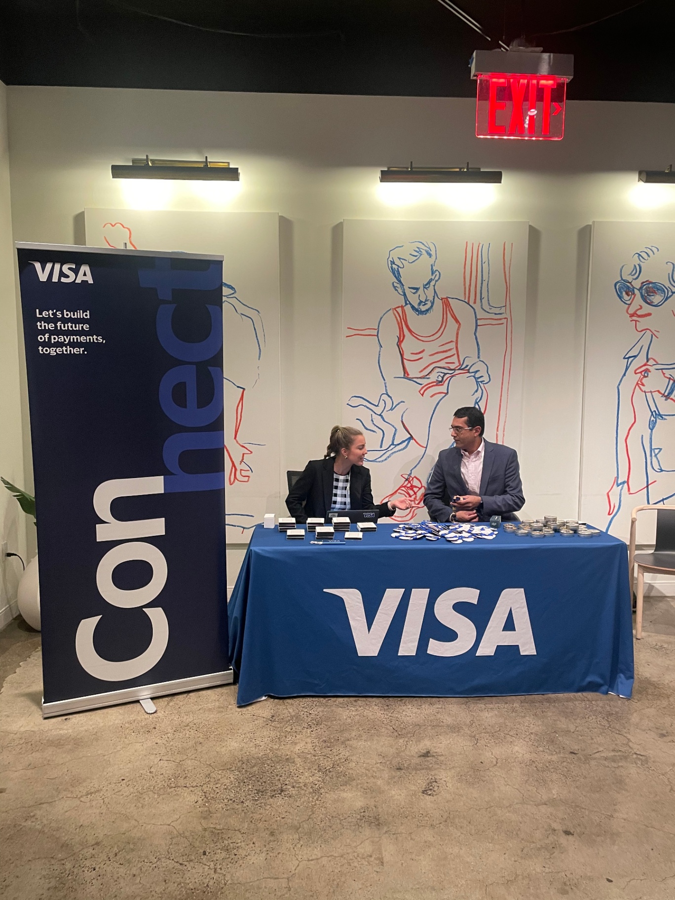 Visa Connect welcome desk with branded banner and giveaways at CPI Global 2023