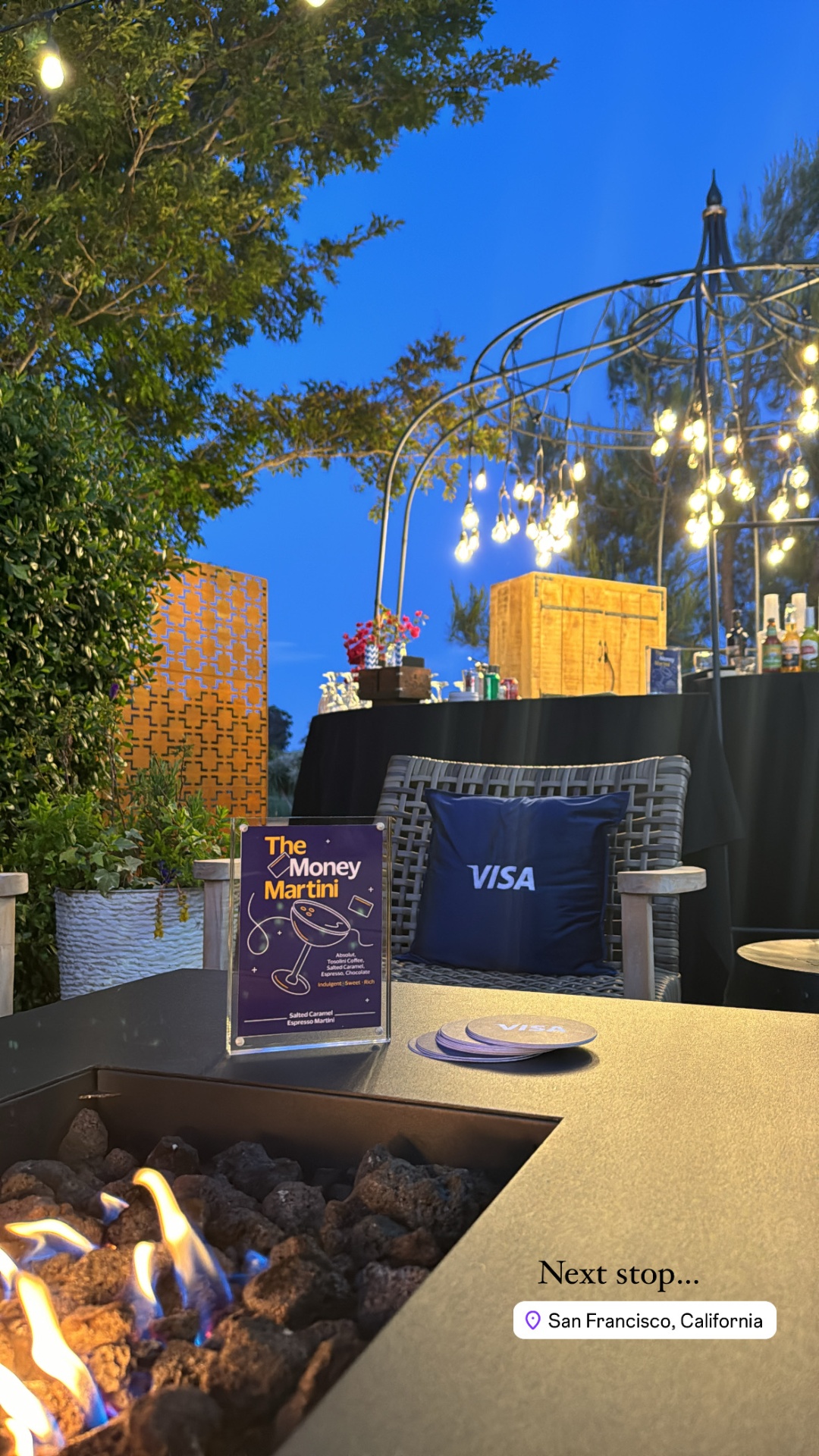 Evening bar setup under bistro lights at the Visa Data Summit reception
