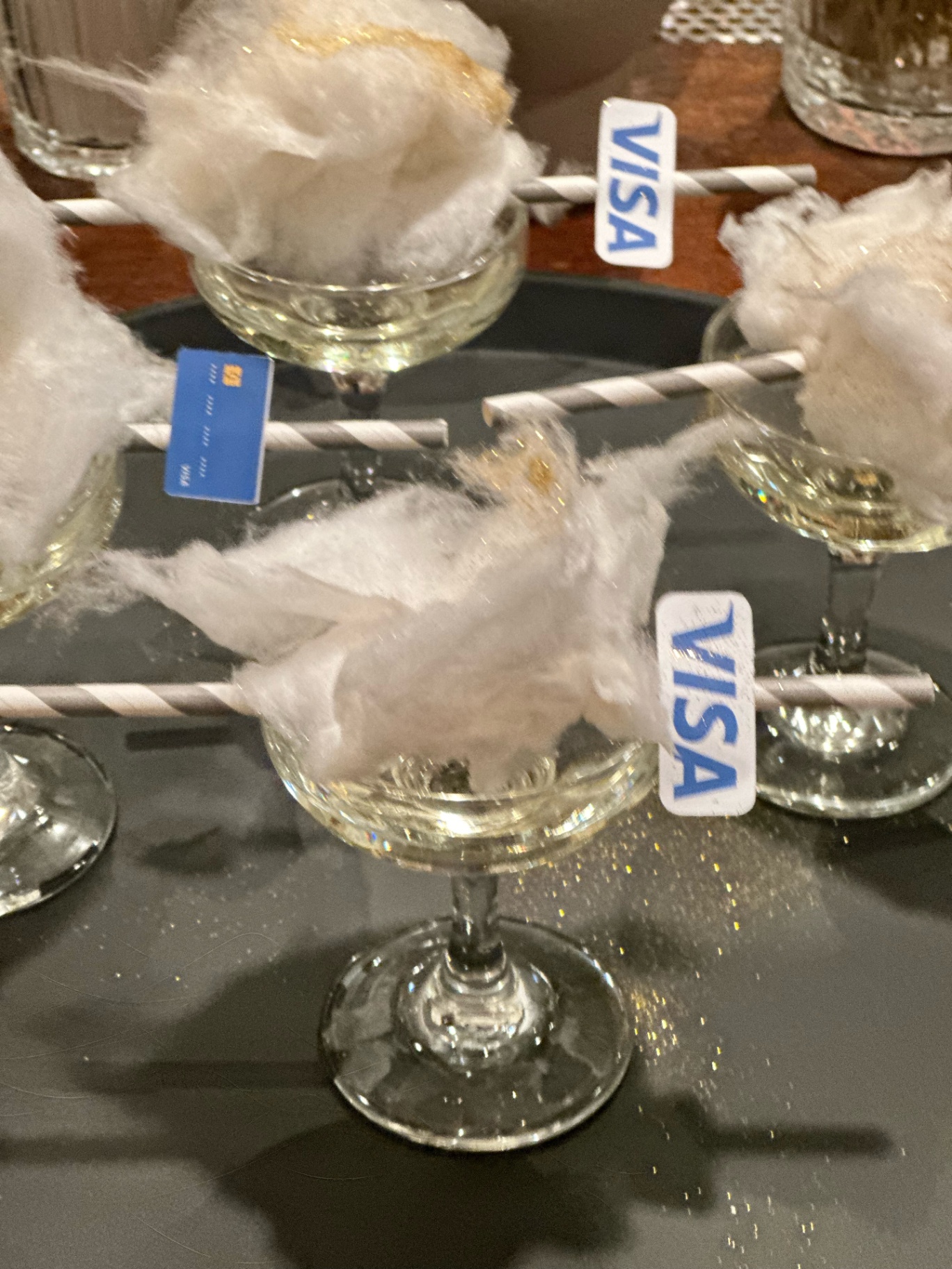 Close-up of cotton candy cocktails with Visa-branded straws
