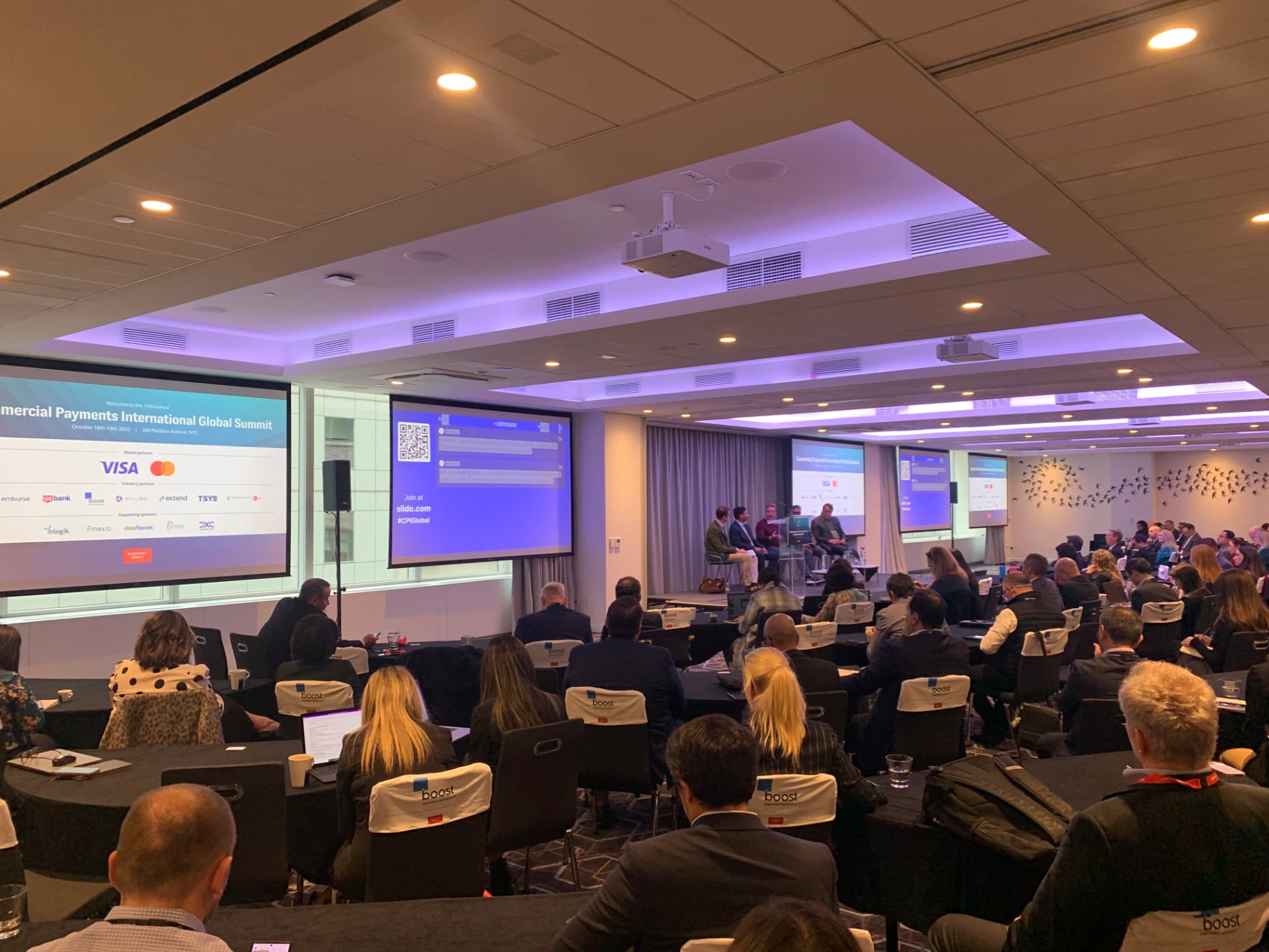 Audience watching the Slido Q&A screens during a CPI Global 2022 panel