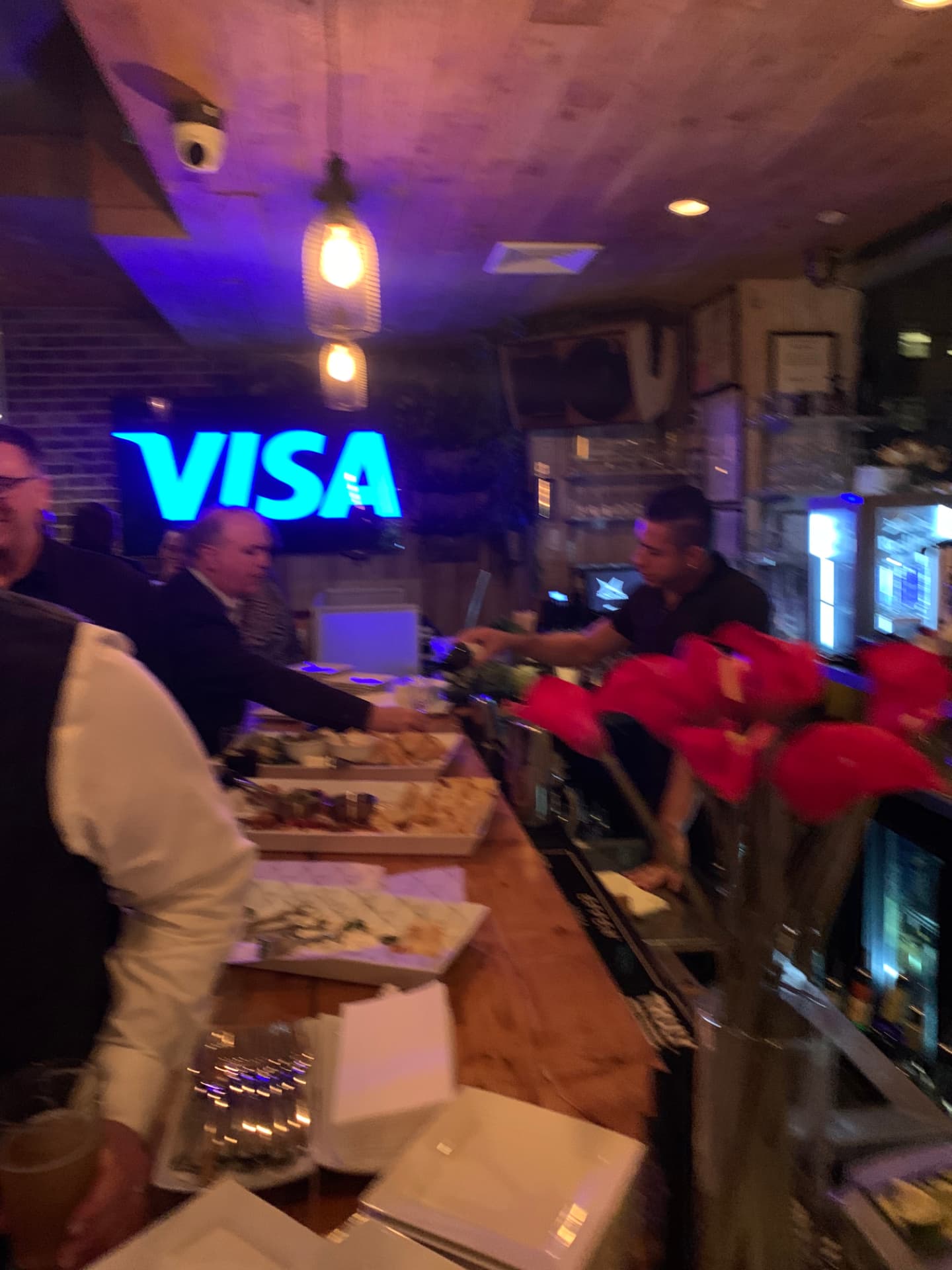 Guests served at the bar beside the cheese and charcuterie spread