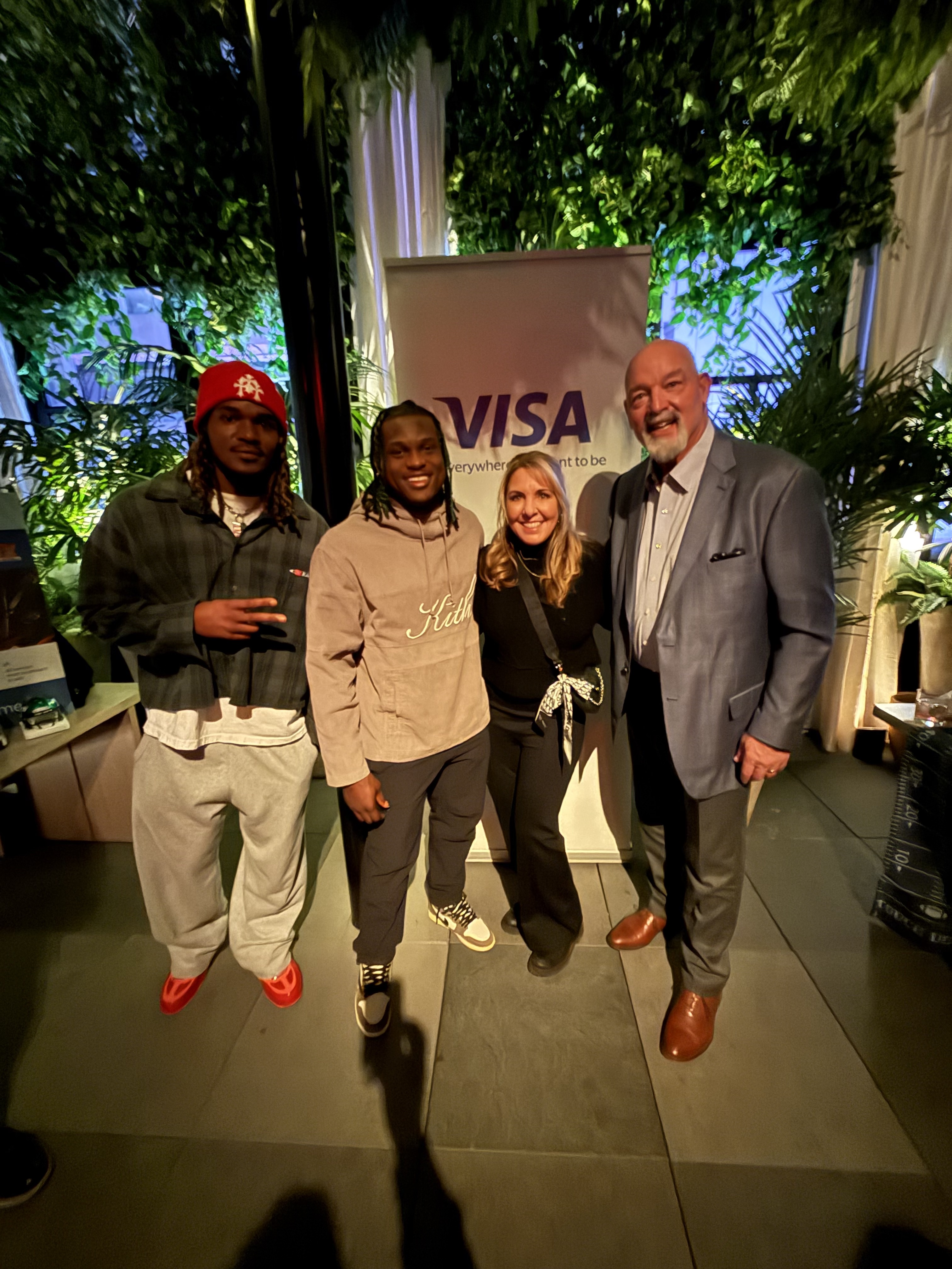 Guests posing together in front of the Visa banner at CPI Global 2024