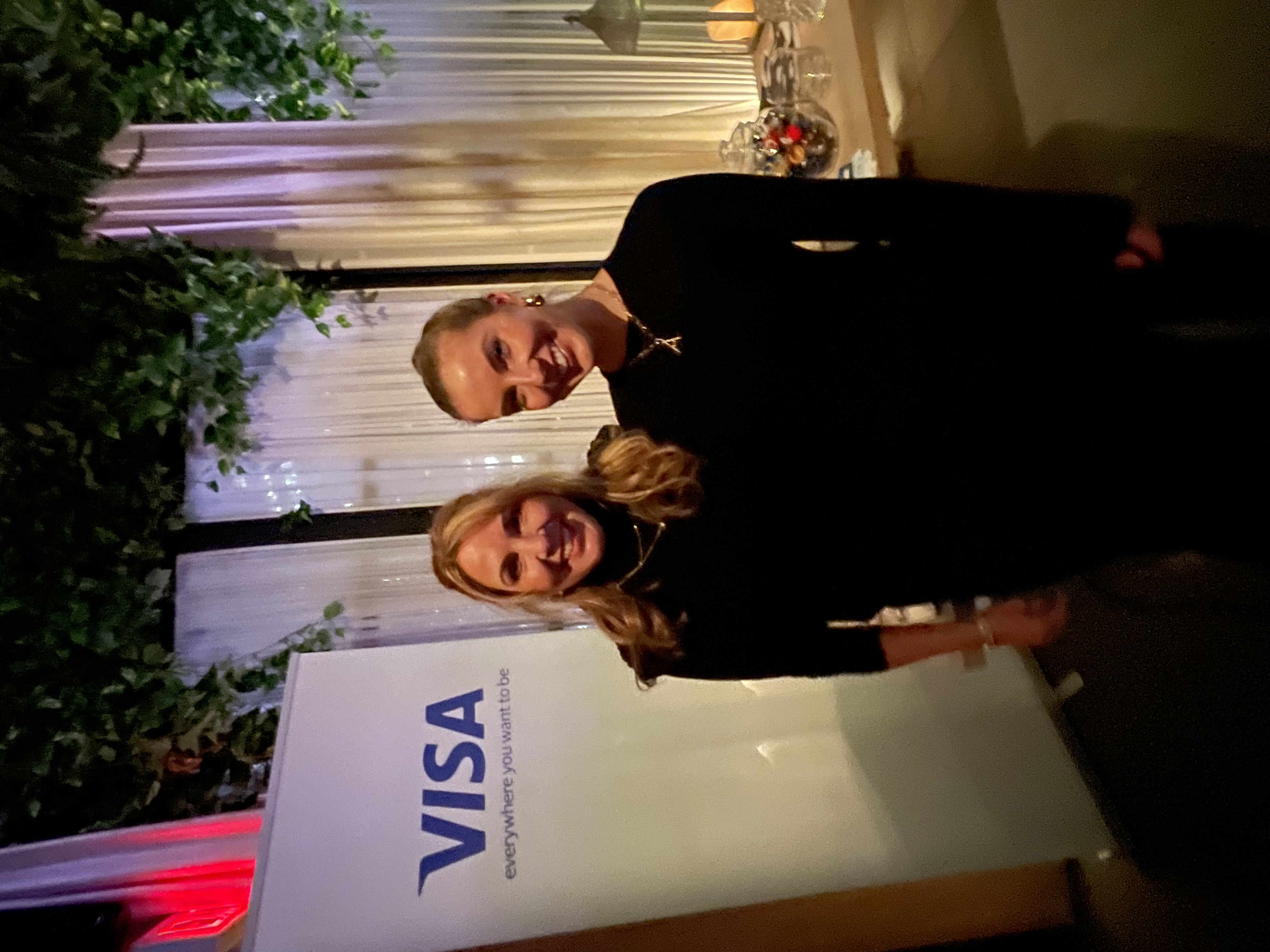 Guests gathered by the Visa signage during the evening reception
